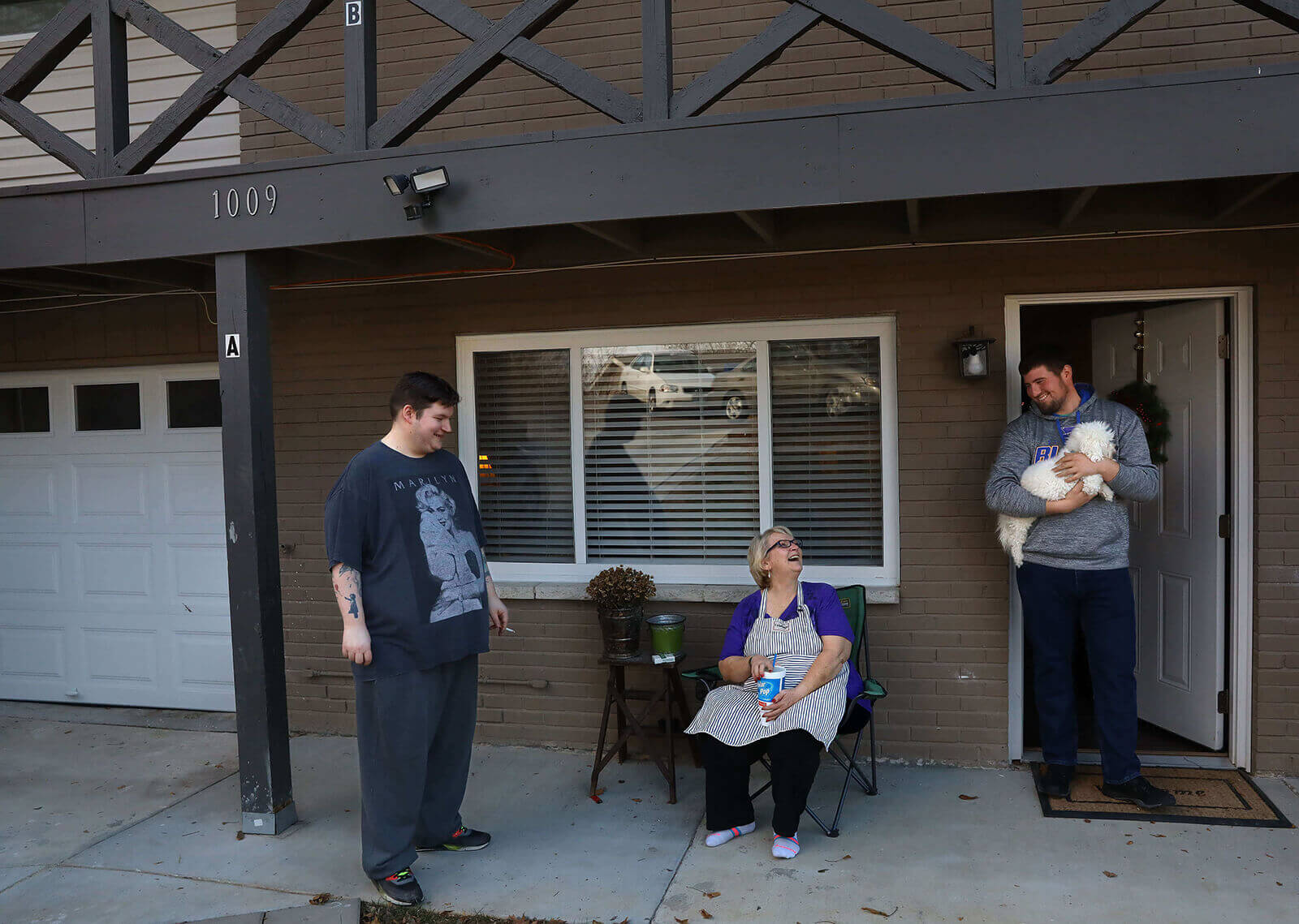 Lonni Schicker talks with her son, Dan Schicker, (left), and his friend Cameron Flood on Sunday Dec. 17, 2017, while she takes a break from cooking a big holiday meal for Dan and many of his friends.