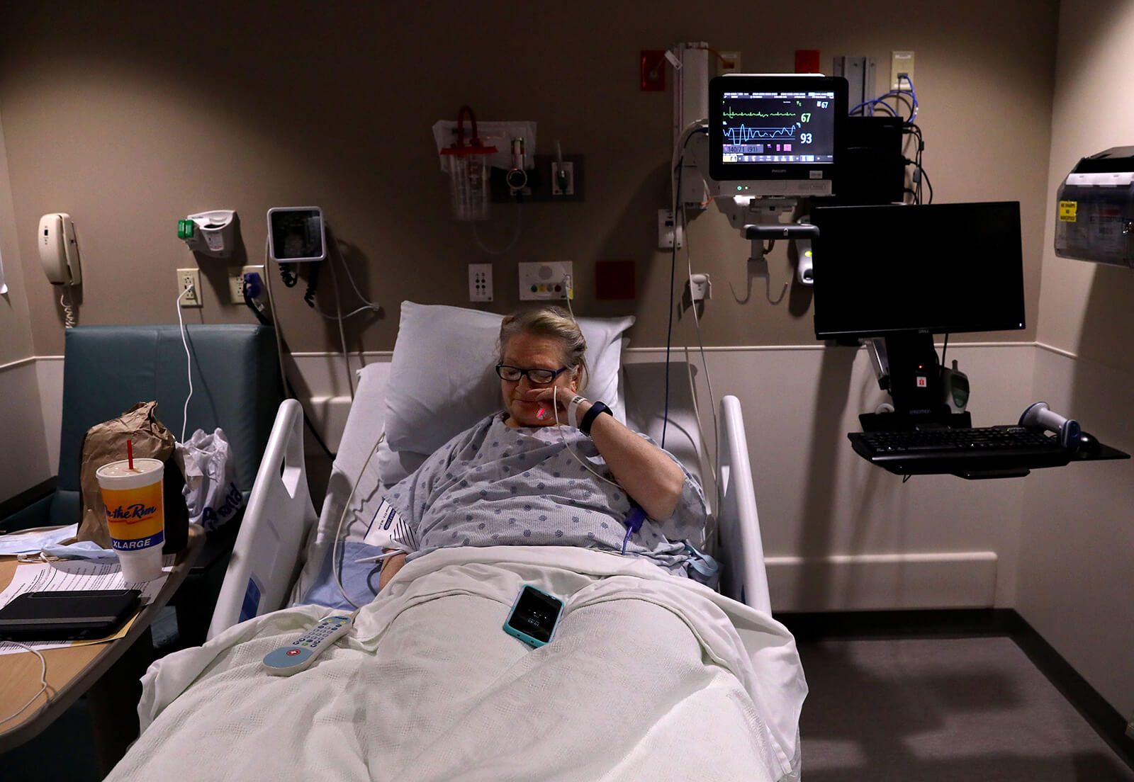 Lonni Schicker settles into her bed at Mercy Hospital in Des Peres after having chest pains on Thursday, Feb. 1, 2018. She was to undergo a round of stress tests the next day. Dan Schicker, her son, came after work.