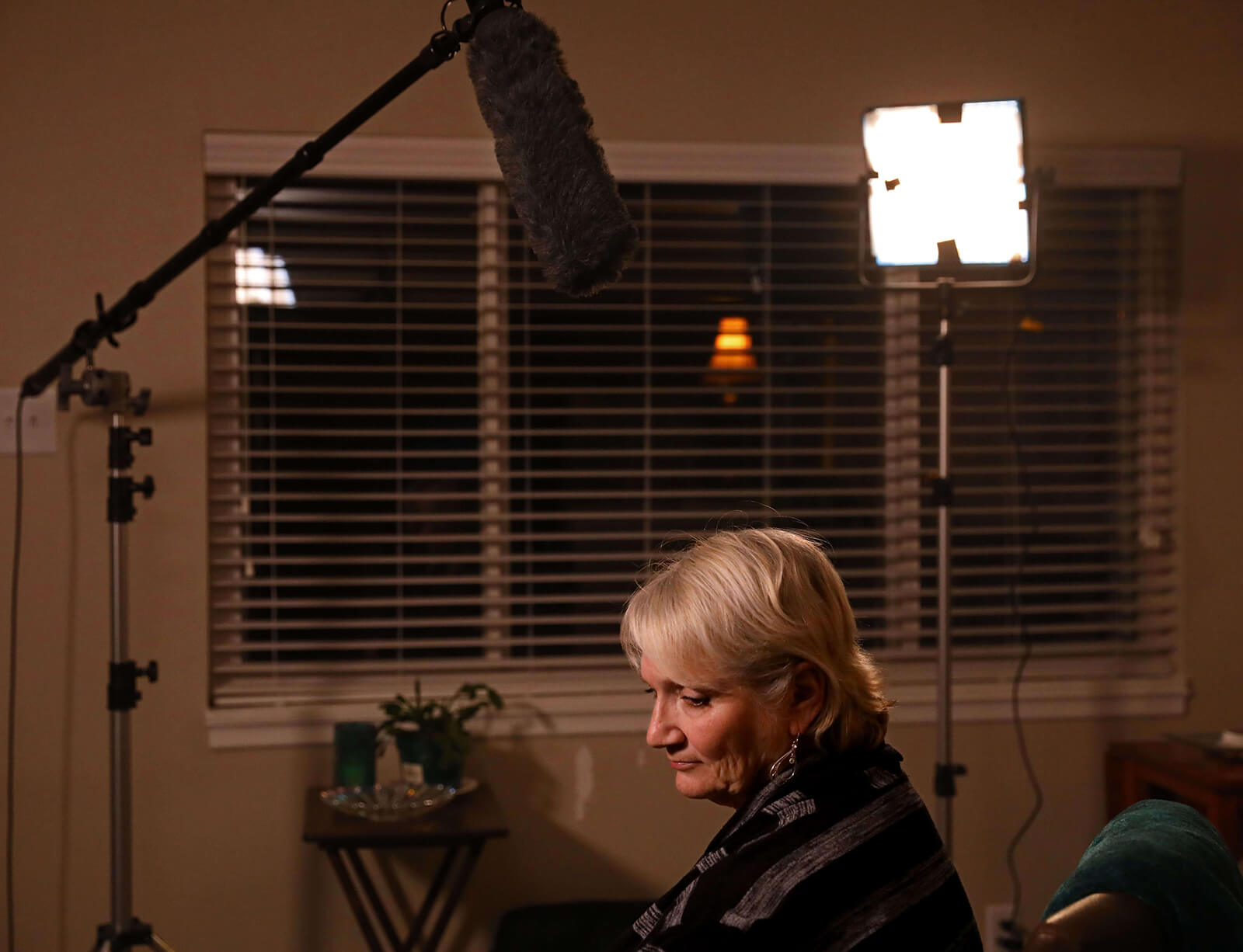 Lonni Schicker waits patiently in her Fenton living room while a video crew sets up equipment on Wednesday, Jan. 31, 2018, to record a piece to be played at an Alzheimer's Association fundraiser scheduled for April. Since being diagnosed with mild cognitive impairment, Lonni has committed herself to being an advocate for the organization; telling people about her experience with dementia.