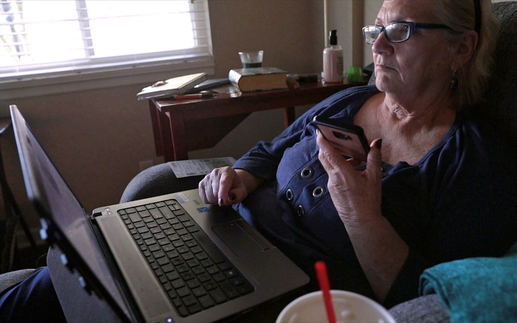 Lonni Schicker, 63, of Fenton, listens in on a conference call about a national research summit on ways to support people with dementia and their caregivers on Wednesday, June 13, 2018.