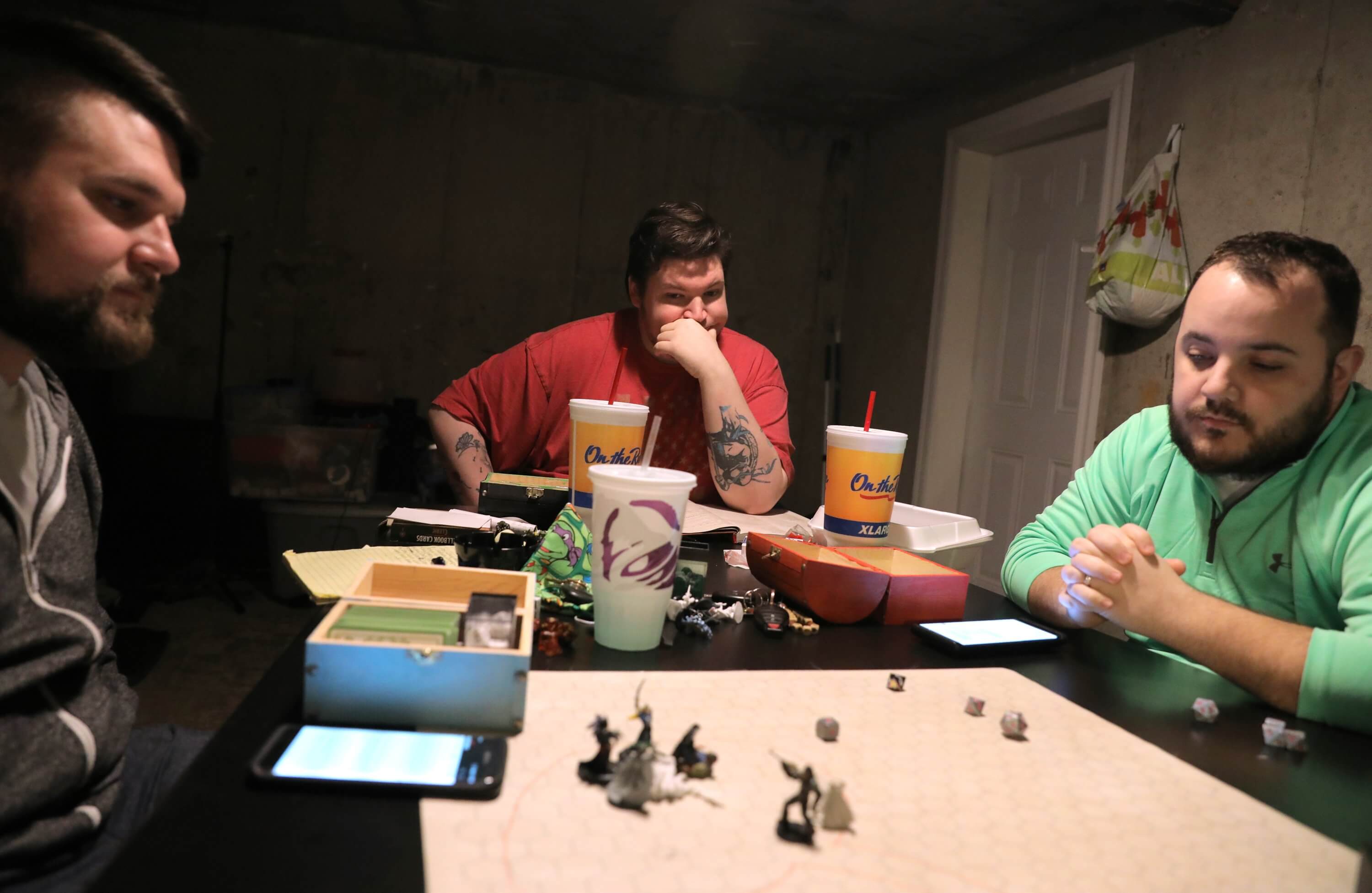 Dan Schicker (center), 31, plays Dungeons and Dragons with friends Tim Cox (left), 28, of House Springs, and Brandon Bardenheier, 30, of Fenton, in the garage of the apartment in Fenton he shares with his mom, Lonni, on Sunday, Feb. 11, 2018. Dan later sold his gaming equipment to help pay bills as he and his mother struggled with financial issues brought on by her dementia.