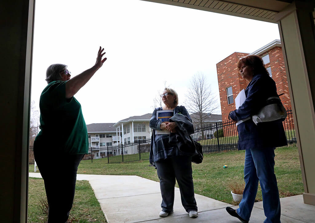 Lonni Schicker (center) and her friend Susan Miller listen as Janis McGillick gives a personal tour of the grounds of Dolan Memory Care Home on Friday, March 23, 2018, in west St. Louis County. McGillick is the director of community engagement for the company that runs the home. Lonni wanted to see what kinds of facilities were available and how much they cost.