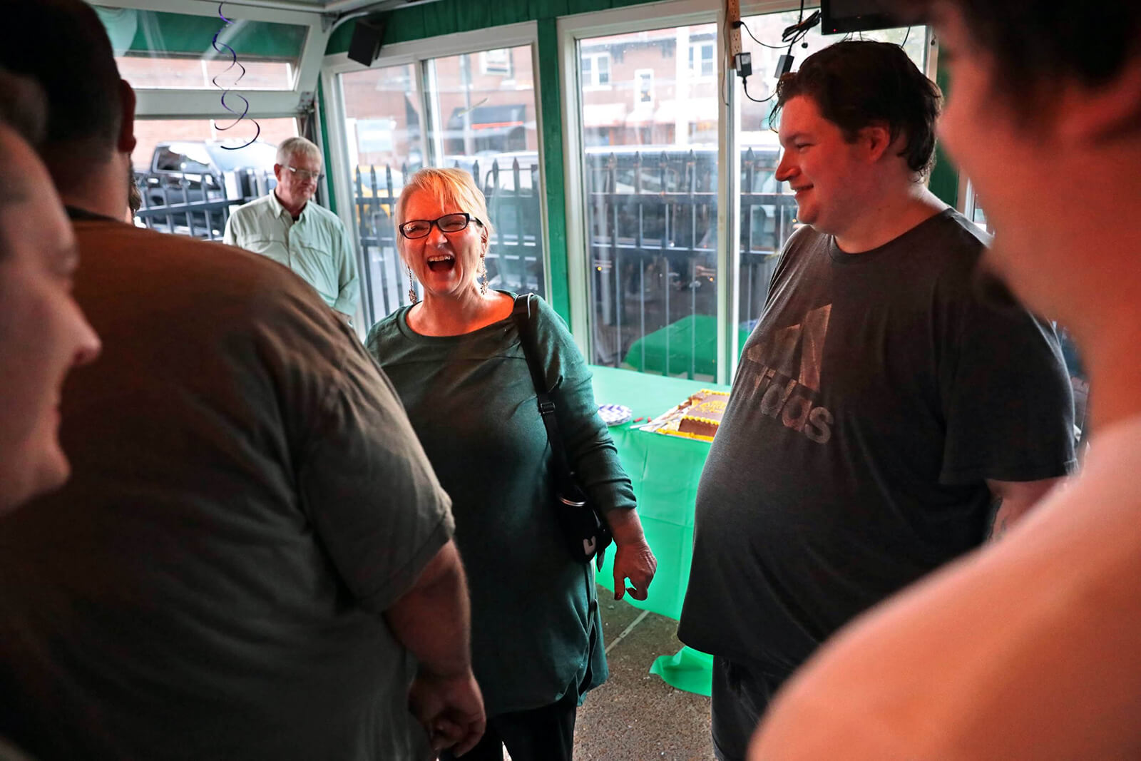 Lonni Schicker laughs next to her son, Dan Schicker, as he recounts to friends and family how he successfully pulled off a surprise birthday party at Seamus McDaniel's on Saturday, Sept. 29, 2018. He says he wanted to make it a surprise because she gets anxious when she knows a big event is coming up.
