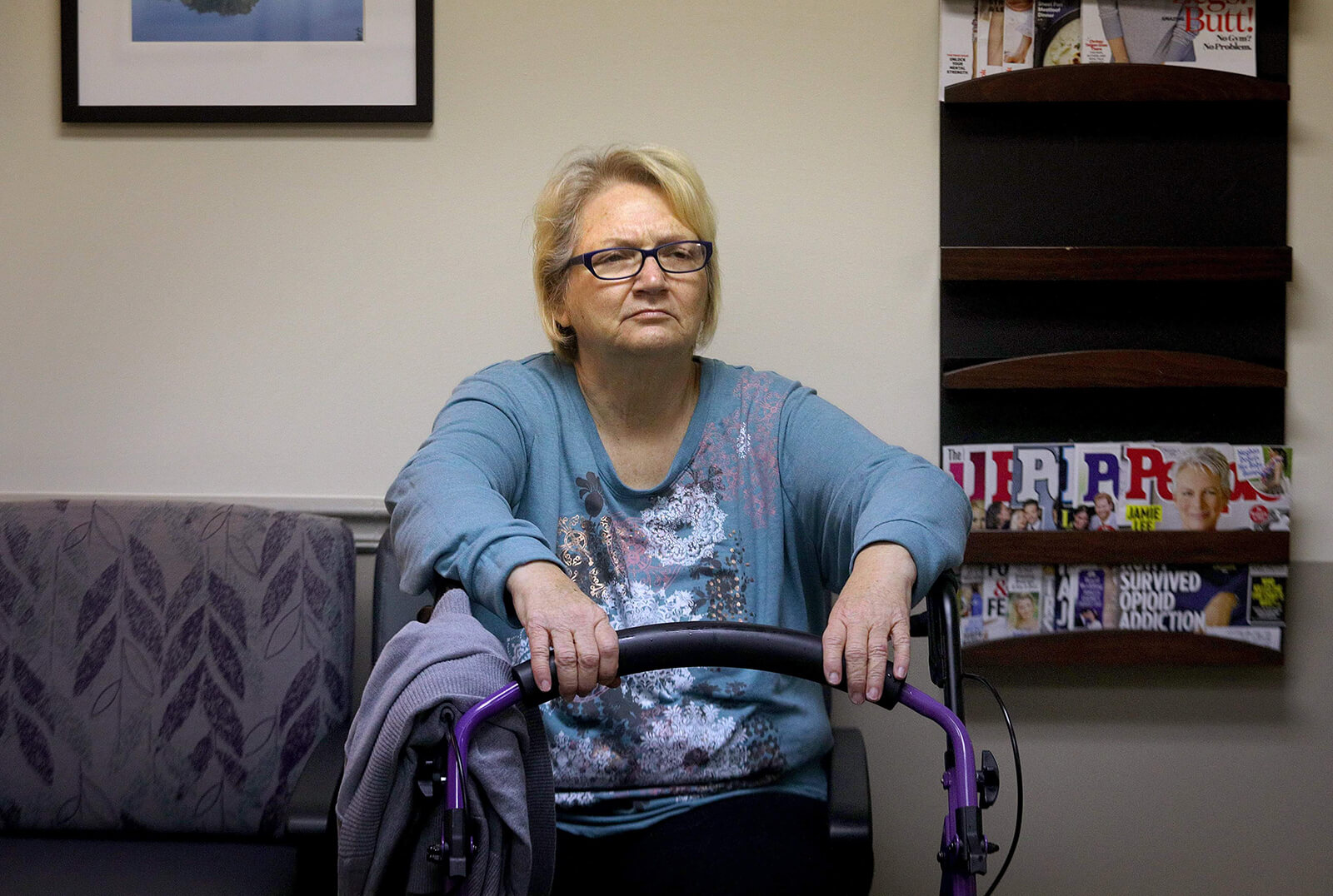 Lonni Schicker takes a seat in the waiting room on Tuesday, Nov. 1, 2018, before a followup visit with her neurologist at Mercy Hospital St. Louis. Twice while she is waiting, she asks her son what the date is. She says her short-term memory has worsened and her hands shake more.