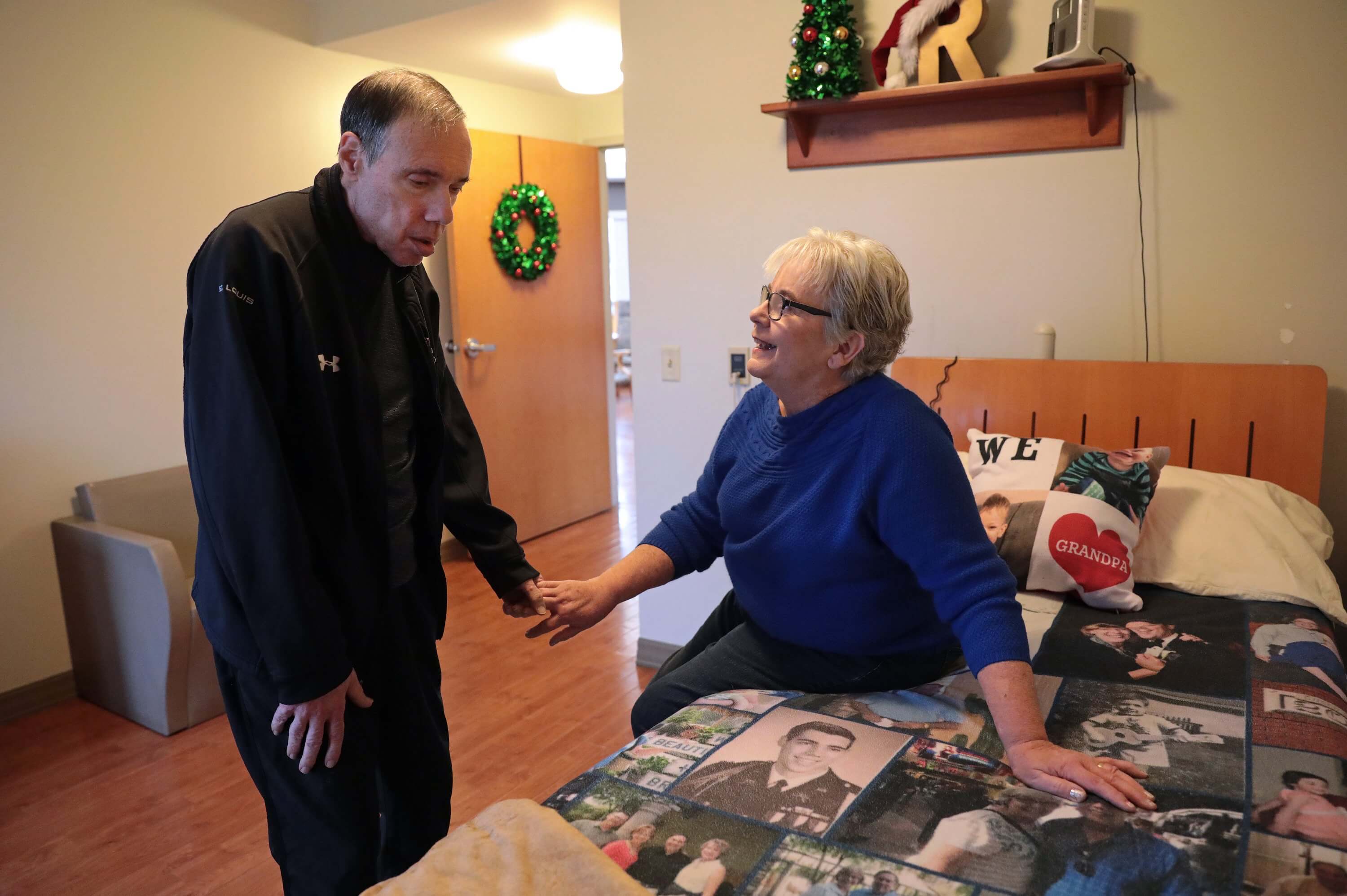 Mary Nicoletti, 66, visits Ron, 68, her husband of 45 years, at a skilled nursing facility in Valley Park on Thursday, Dec. 13, 2018. Ron was diagnosed with early onset Alzheimer's when he was 60 and his problems probably started four years before that, his wife says. “I was just ignorant,” she says. “I had no idea that someone at that age could have problems mentally.”